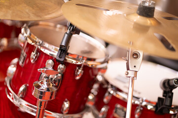 Fototapeta na wymiar Complete set of cymbal instruments with complete red drums in studio music concept