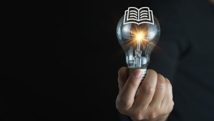 light bulb glowing on book, idea of ​​inspiration from reading, innovation idea concept, Self...
