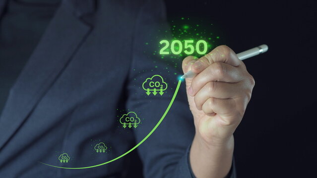 Businessman point to increasing arrow with carbon reduction for for decrease CO2 , carbon footprint and carbon credit to limit global warming from climate change, Bio Circular Green Economy concept.