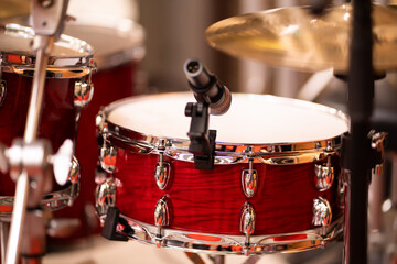 Fototapeta na wymiar Complete set of musical instruments with complete set of red drums in studio music concept