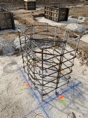 Close up shot of a reinforced column in a construction site on a concrete footing. Process of building a concrete foundation. 