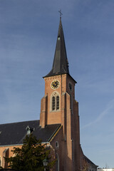 View of St. Gertrudes Church and church tower,  in Wichelen in East Flanders, Belgium, on a bright...