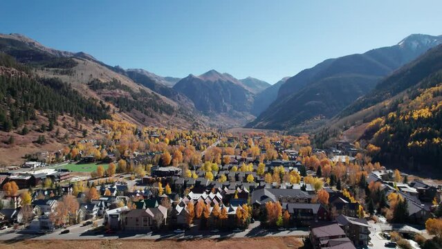 Panning and rising drone shot of Telluride Colorado with lots of fall colors