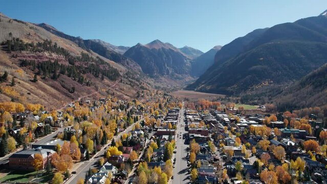 Drone shot panning to the right across the center of the town of Telluride, CO