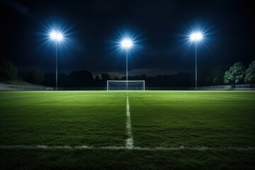 football field illuminated by floodlights in anticipation of a match