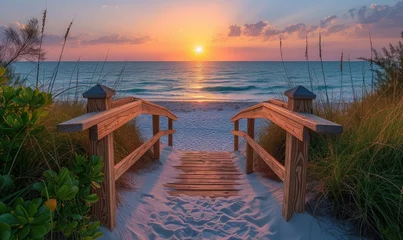 Photo sur Plexiglas Descente vers la plage Long boardwalk leading to white sand beach at sunset