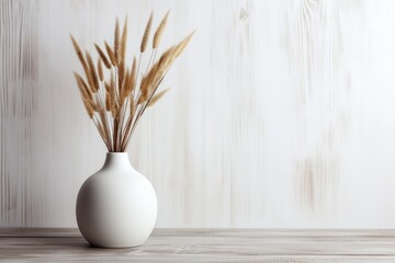 white ceramic vase with dry herbs on a wooden table, minimalist decor