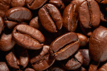 Close up macro shot of roasted coffee beans. Background. Top view.