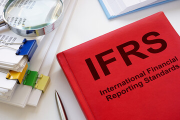 A stack of papers and a book IFRS International Financial Reporting Standards.