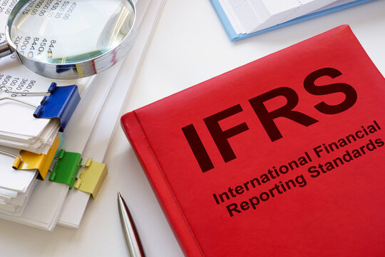 A stack of papers and a book IFRS International Financial Reporting Standards.