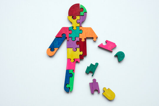 A figurine made from multi-colored puzzles. Psychotherapy and Self-acceptance.