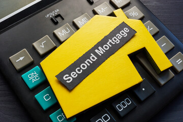Second mortgage inscription, calculator and model of house.