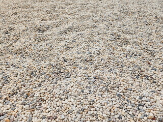 Small boulders on road or decorate your home garden. Pebbles of different shapes, sizes, and colors. Outdoor background design
