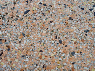 Orange and black pattern of marble stone table top. Stone wall texture,Terrazzo Marble surface floor for background. orange marble table There are white, black, gray, brown, and pebbles decorated.
