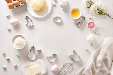Preparation and cook Easter cookies, cookie cutters, raw dough on baking white background. Top...