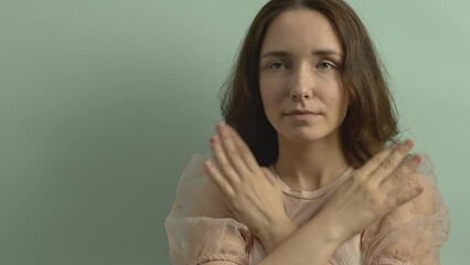 Female touching and tapping her shoulders, crossing hands. Butterfly hug. Psychology and self-care concept. Empty background with copy space.