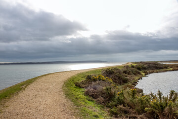 Fototapeta na wymiar Footpath along The Solent Way trail at Lymington Hampshire England on a stormy winter day