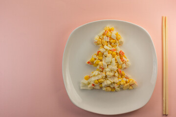 salad in the shape of a Christmas tree with Chinese chopsticks.