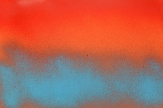 red and blue spray paint on a orange color paper background