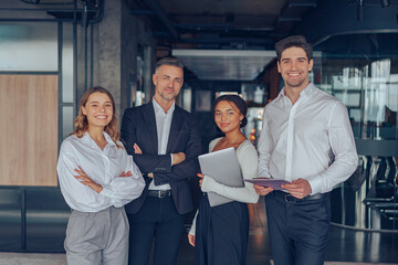 Group of diverse business people standing on office background and looking on camera