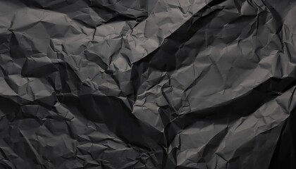 Heavy crumpled black paper texture in low light background