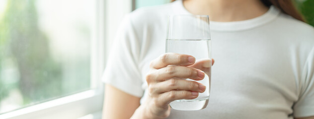 Clean freshwater concept. Woman drink mineral water in the morning for good health.