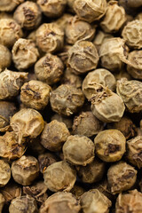 Dry green peppercorns background. Aromatic, organic spice. Top view.