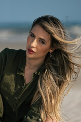 Fototapeta premium young beautiful woman model on the beach in a dress in a fashion photosoot