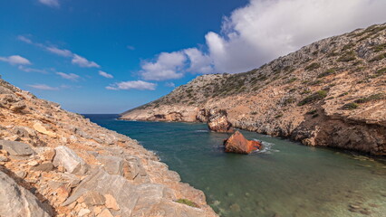 An abandoned rusty ship in the sea timelapse near huge rock formations in Navagio Beach, Amorgos...