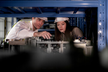 technician engineers team checking the machine and maintenance service. workers looking at spare...