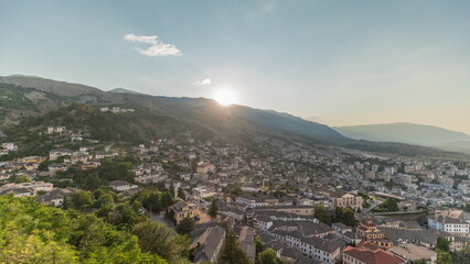 Fototapeta na wymiar Panorama showing sunset over Gjirokastra city from the viewpoint of the fortress of the Ottoman castle of Gjirokaster timelapse.