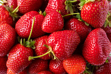 Background of fresh strawberries. Ripe strawberries. Ripe berries close-up. Various fresh summer...