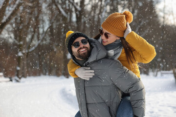 Fototapeta na wymiar Happy young couple having fun outdoors on winter day