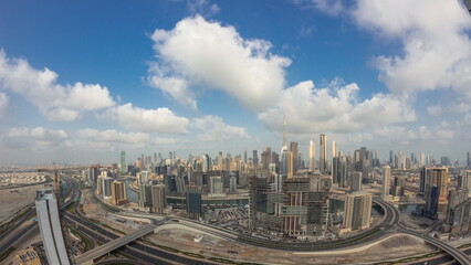 Panoramic skyline of Dubai with business bay and downtown district night to day timelapse.