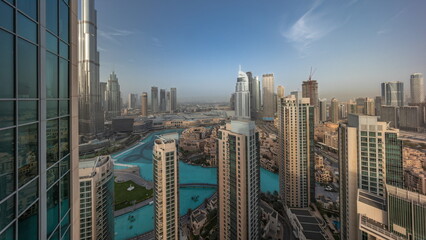 Dubai downtown during sunrise with fountains and modern futuristic architecture aerial timelapse