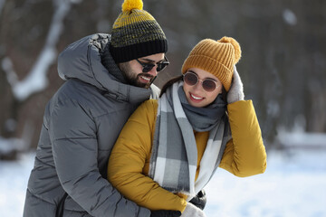 Beautiful happy couple outdoors on winter day