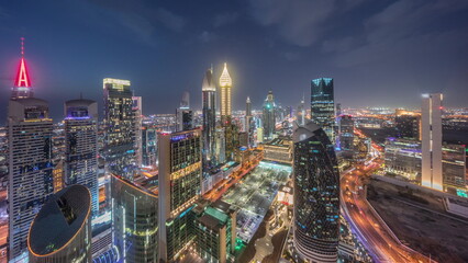 Skyline view of the high-rise buildings on Sheikh Zayed Road in Dubai aerial day to night timelapse, UAE.