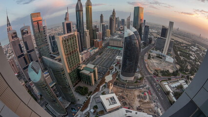 Skyline panorama of the high-rise buildings on Sheikh Zayed Road in Dubai aerial night to day timelapse, UAE.