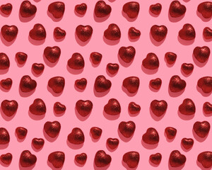 Pattern of red shiny hearts on pink background. Valentine's Day card