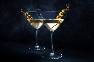 Martini. Two glasses of dirty martini cocktails with vermouth and olives, elegant aperitif, on a...