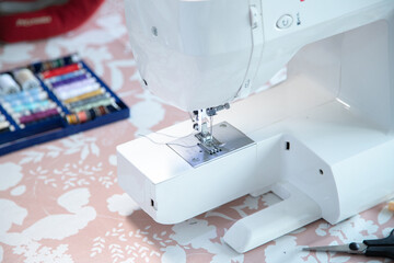 Sewing machine and some accessories, workspace at home or workshop.