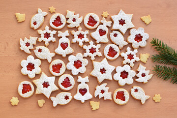 Various shapes of Linzer cookies filled with strawberry jam. Christmas baking