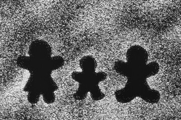 Parents and child silhouettes made of powdered sugar