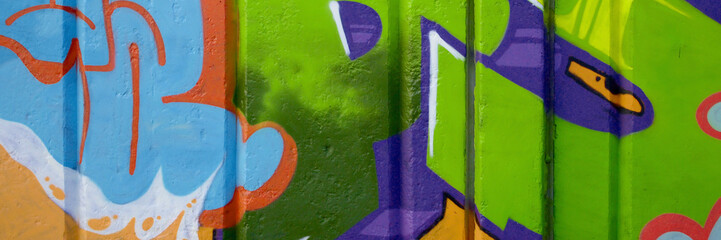 Colorful background of graffiti painting artwork with bright aerosol outlines on wall. Old school...