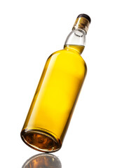 Tilted bottle of whisky, isolated on a white background.