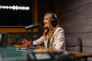 Cheerful young woman recording podcast in studio with copy space