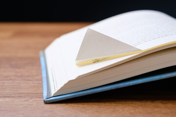 Folded corner paper of the book, fold down page of current reading, important quotes, meaning phrase of the story