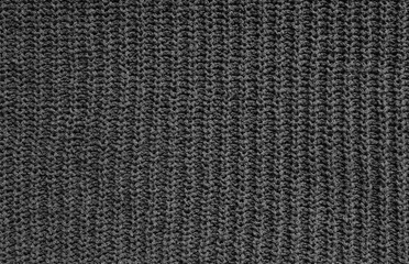 Background with Dark Gray Knitted Fabric, Visible Inaccurate Loose Weave. Rough Texture of Knitted Sweater. No text. Woolen Material Structure.