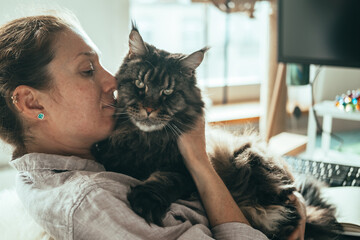 Woman Embracing Her Maine Coon Cat