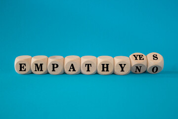 Empathy yes or no symbol. Turned wooden cubes and changes words empathy no to empathy yes on a...